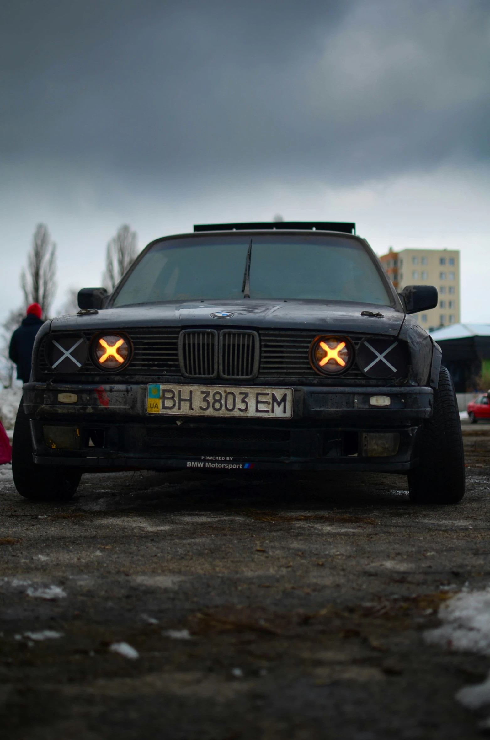 a car is sitting out on a parking lot near other cars