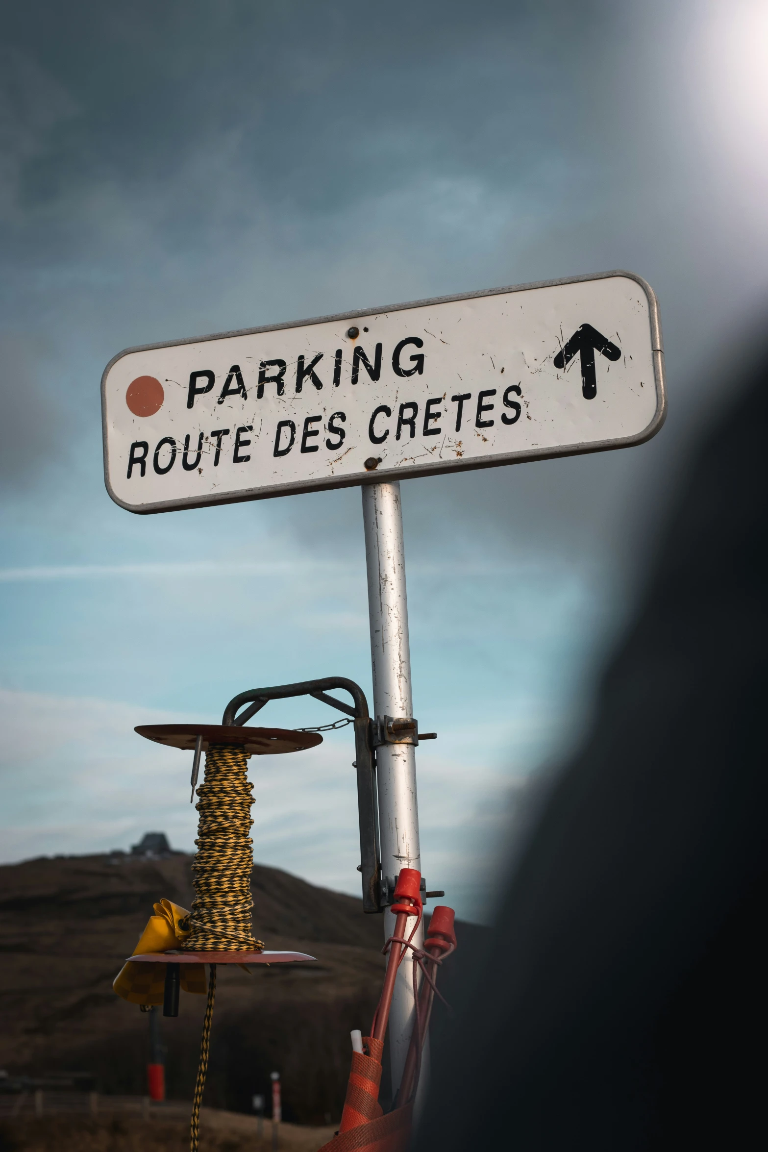 street signs on top of a pole with electrical wires below