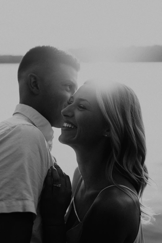 a couple is kissing while standing close together