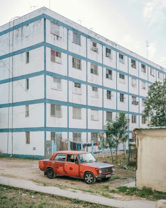 an old truck parked near a tall building