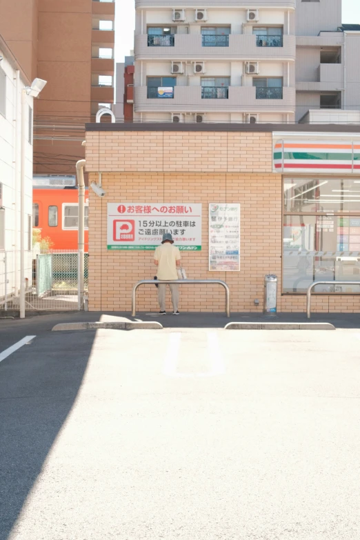 a lone man sitting on a bench on a street