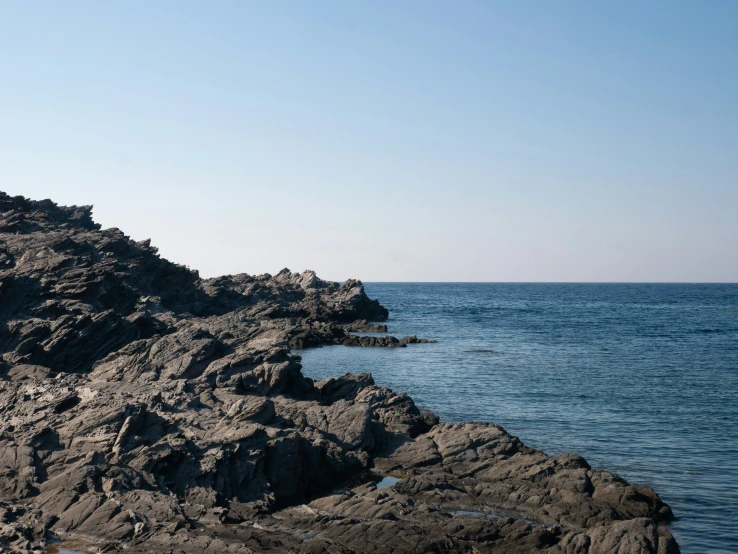 a couple of large rocks sitting on the shore