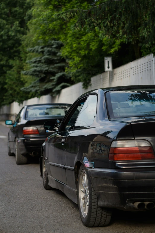 four cars lined up in rows along the sidewalk