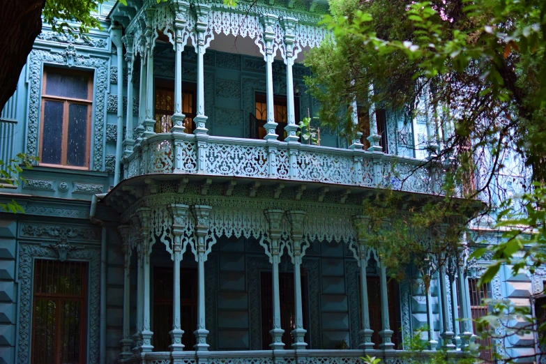 an elaborately painted house with large tree