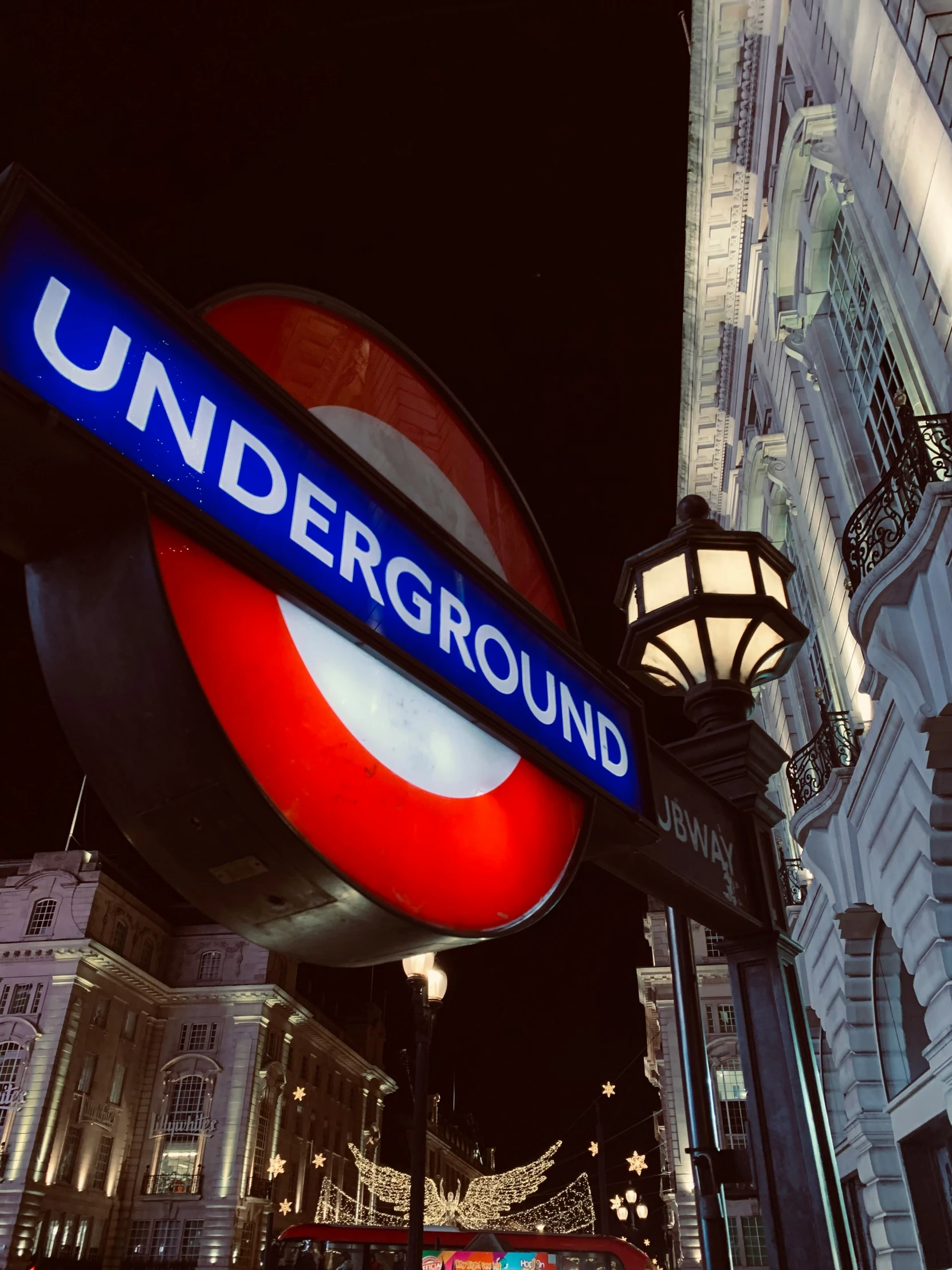 an underground sign mounted to the side of a pole