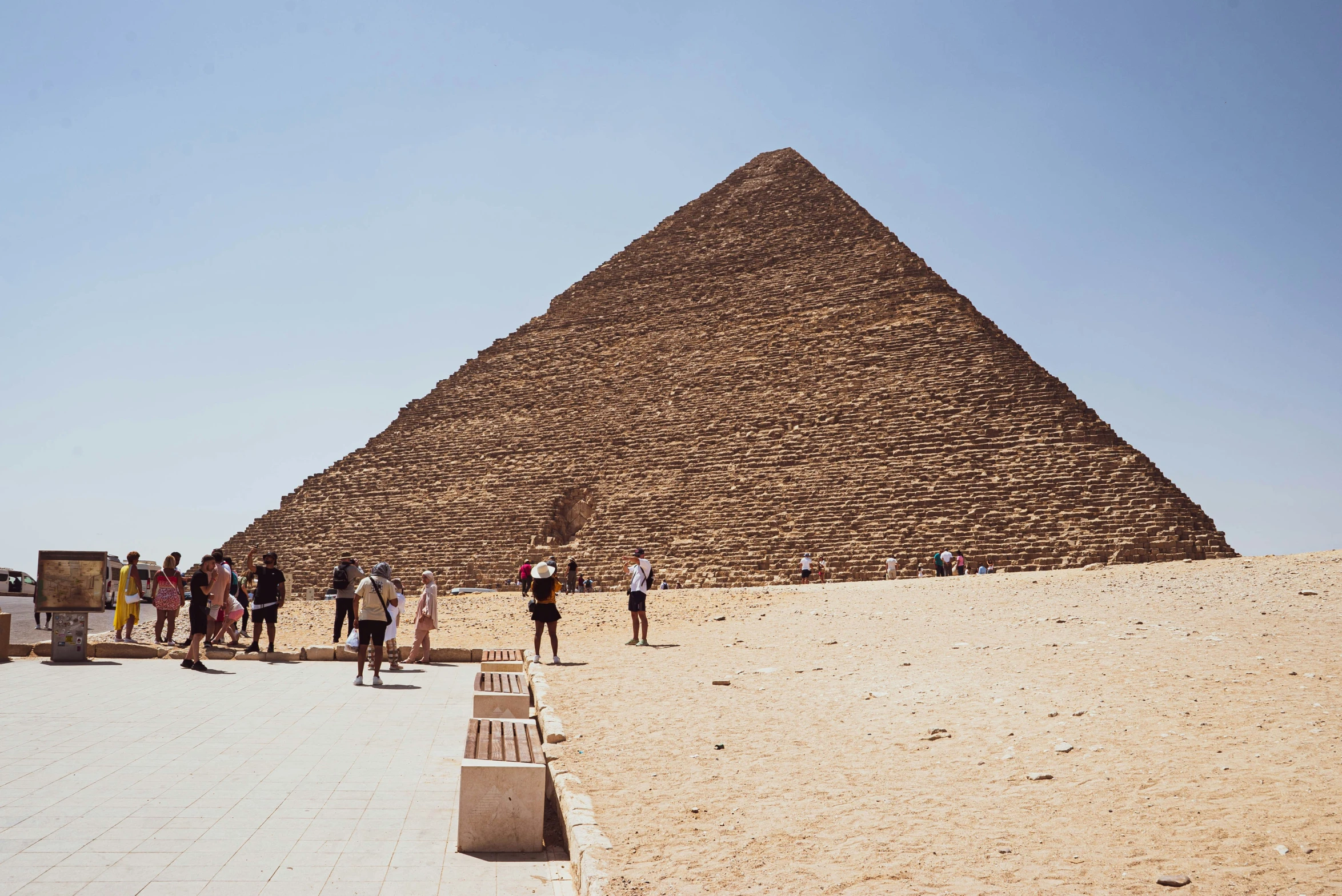 several people walking towards the step of the great pyramid