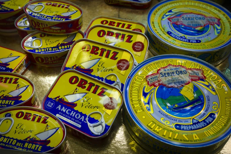 tins with different colored label designs on them