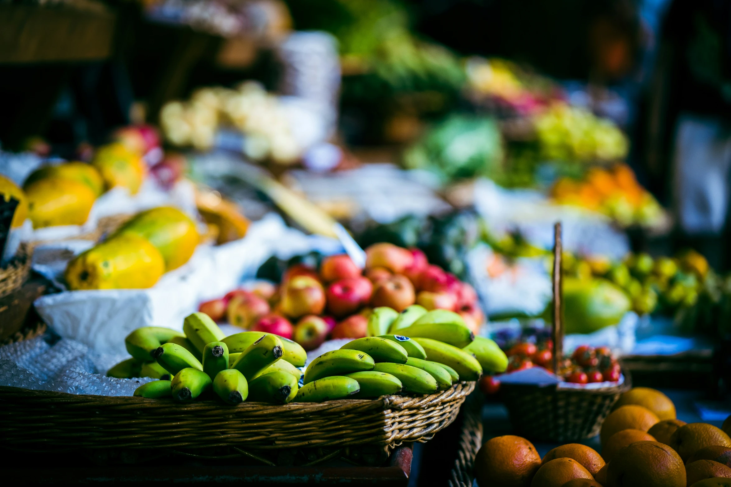 fruit baskets with assorted fruit in them sit on display