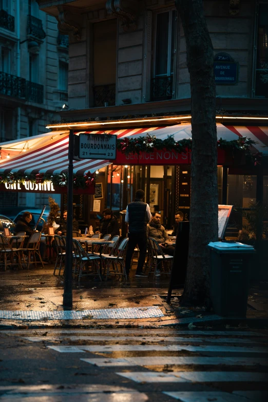 an umbrella shade the sidewalk in front of a restaurant