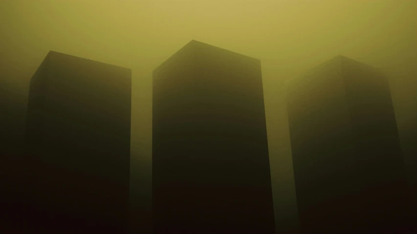 three buildings in the fog with the building tower visible