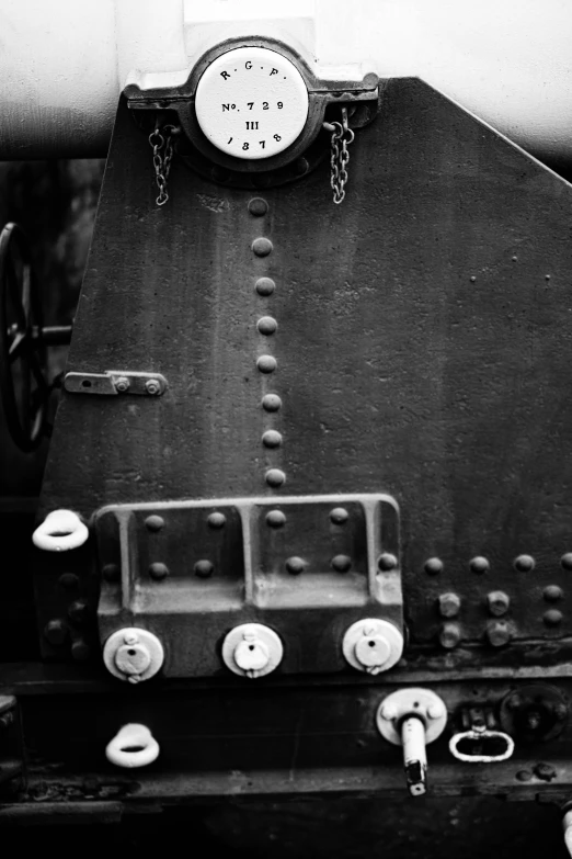 a close up of a clock mounted on the wall of a ship