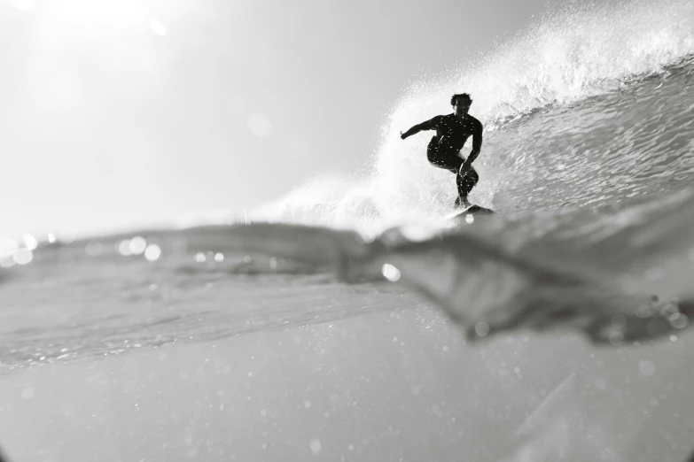 a surfer is catching the wave as it crashes