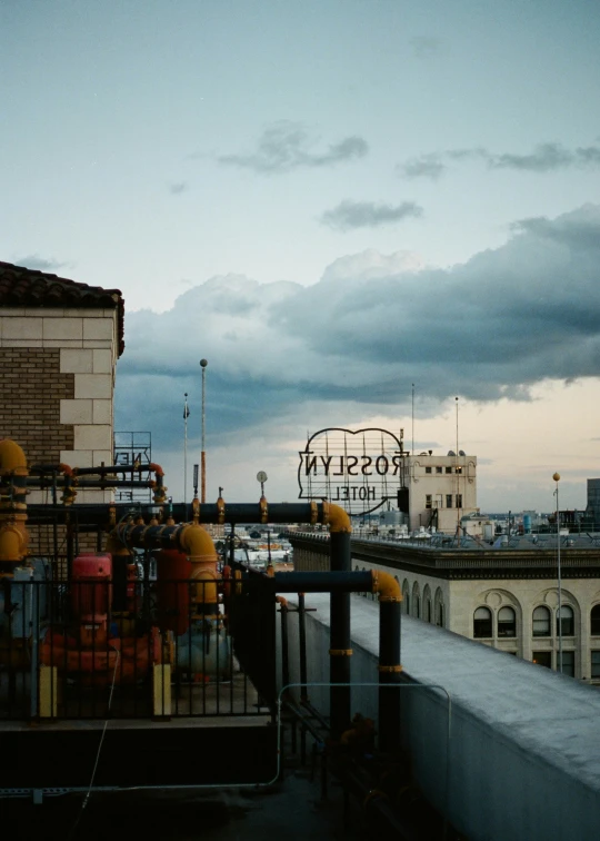 some signs on a building with a cloudy sky