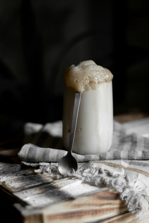 a spoon with powdered sugar on it sitting on a piece of cloth