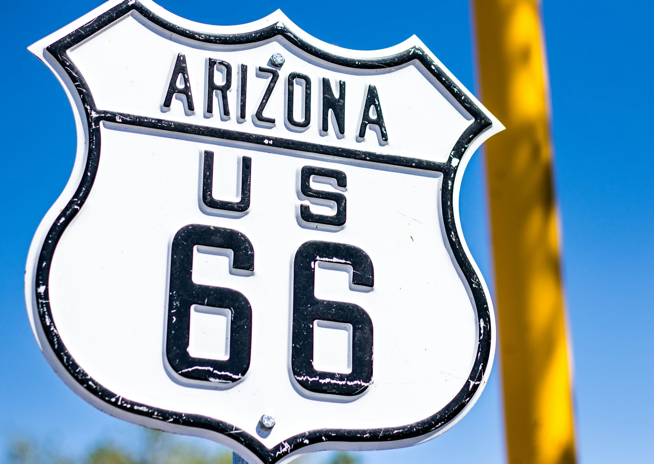 an interstate sign on a street corner in front of a blue sky