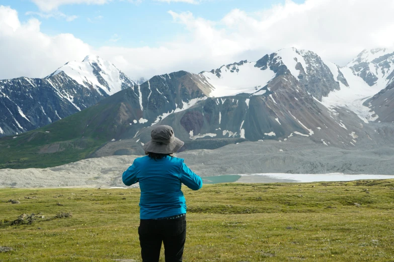 a person in an open field flying a kite