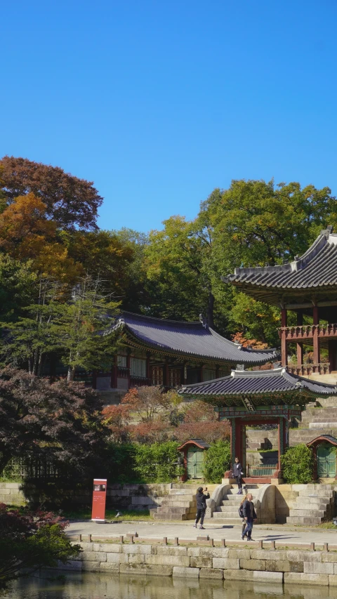 the view from across the water of a chinese garden