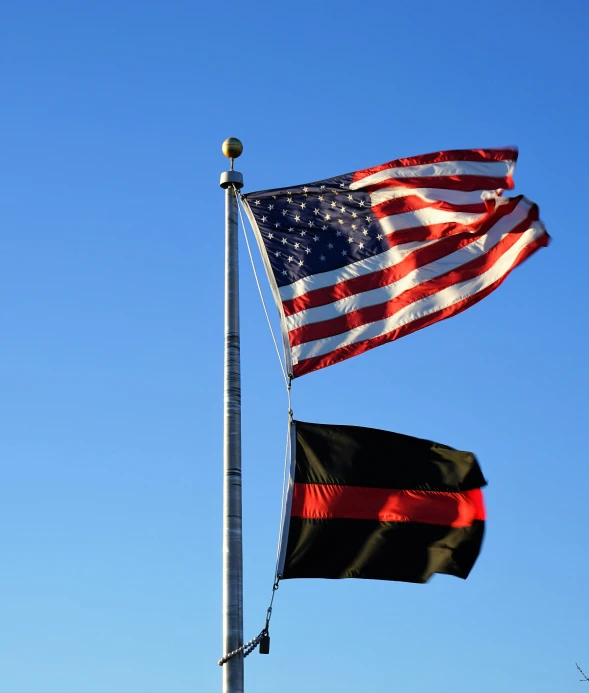 american flag with a german american flag waving in the wind