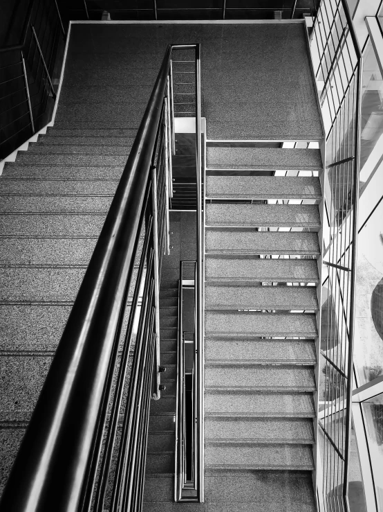 the metal staircases have glass panels on each side