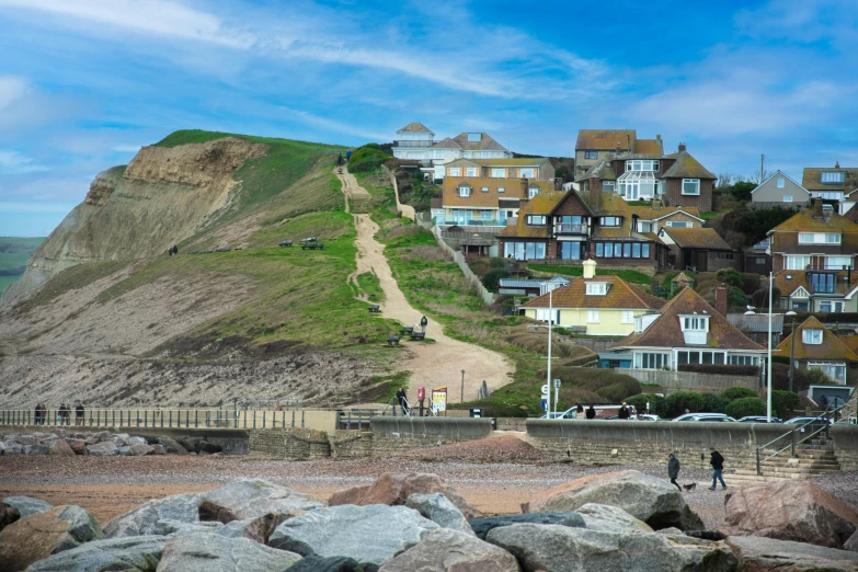 houses on hillside with man in bike and walking