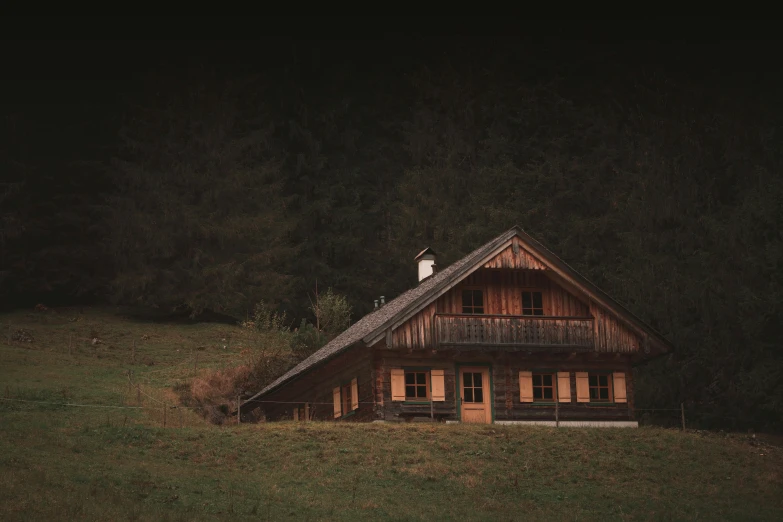 an old wood cabin on the edge of a field