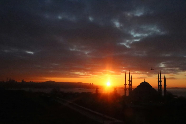 a dark sunset with some building visible from below