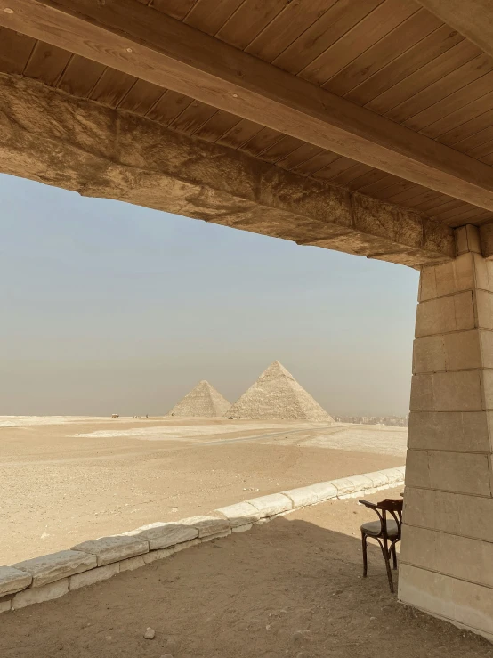 two pyramids near the ocean under a covered walkway