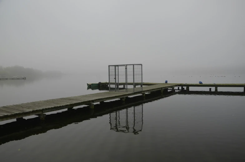 some docks sitting on the water with fog