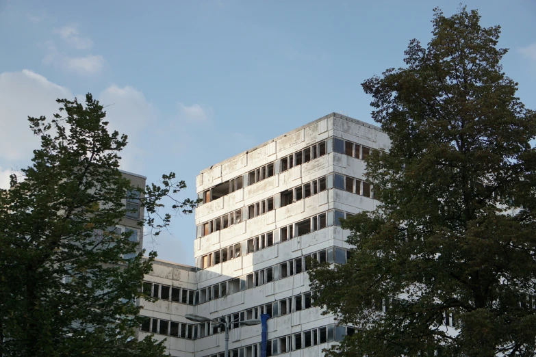 an architectural structure is shown from between some trees