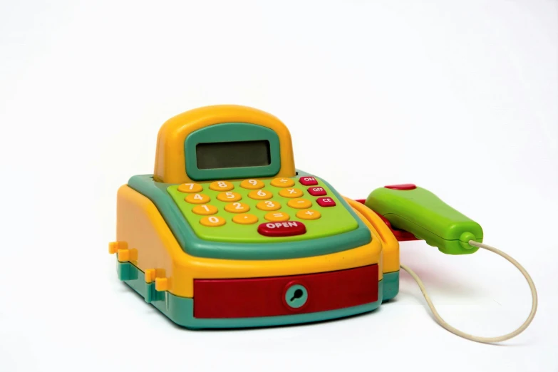 a toy phone with a green cord coming out of it