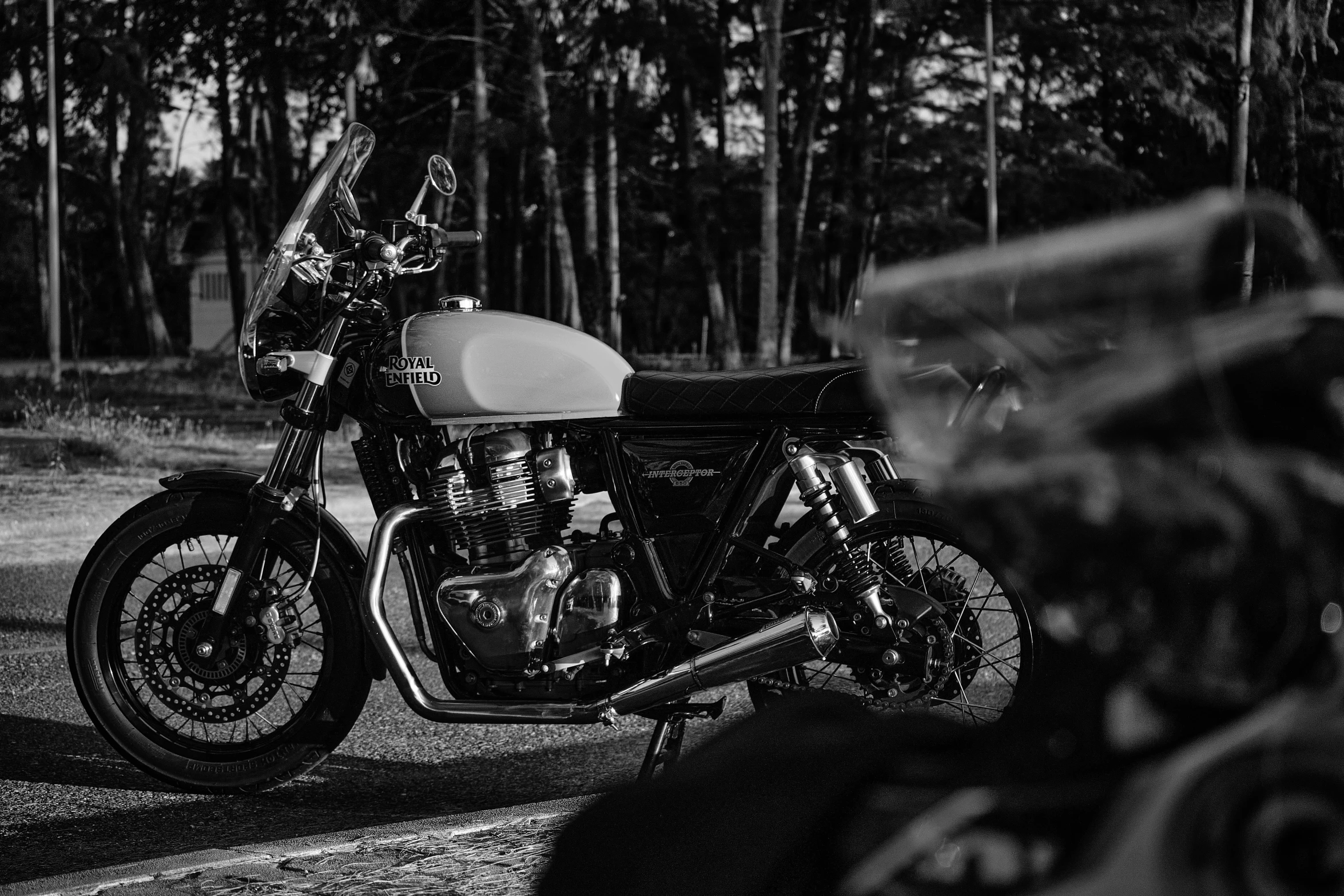 a motor bike parked next to some trees