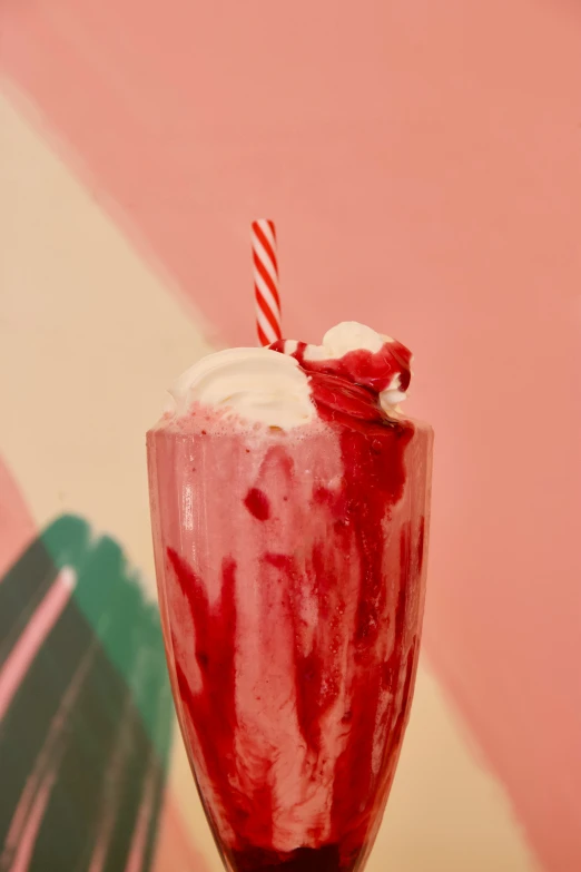 red swirled drink with whipped cream and candy cane