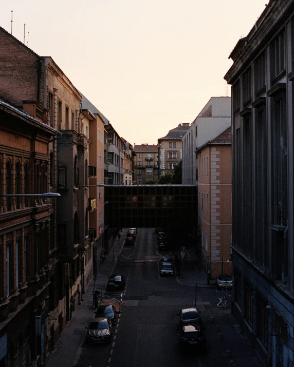 a sunset view of a couple of buildings from an alleyway