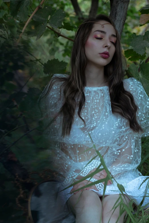 a young woman sitting on a tree nch