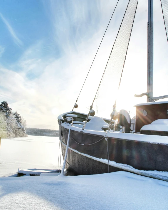 a boat sitting on top of snow covered ground