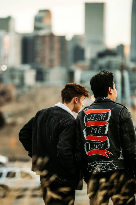 two men walking away from the camera, holding hands