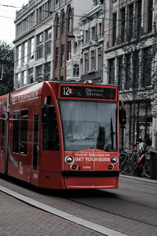 a transit bus on a city street next to tall buildings