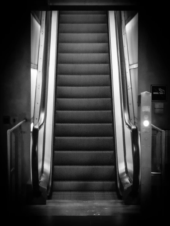 an escalator going down in a black and white po