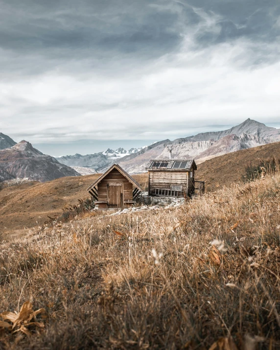 an abandoned wood cabin in a field