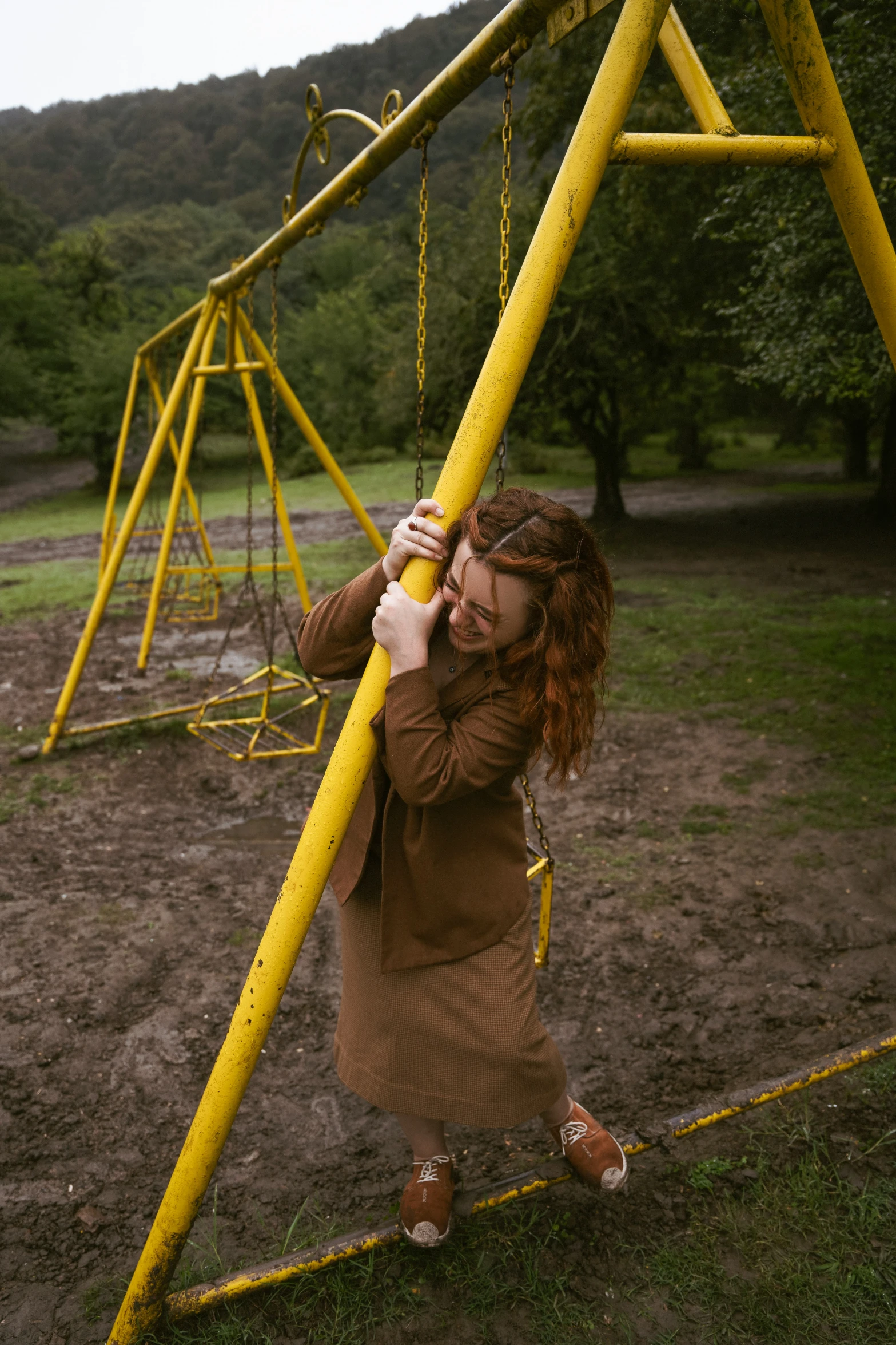 a woman holds a yellow pole in front of her