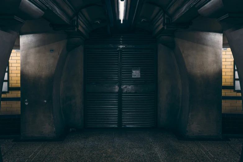 a closed door in a narrow, dimly lit room