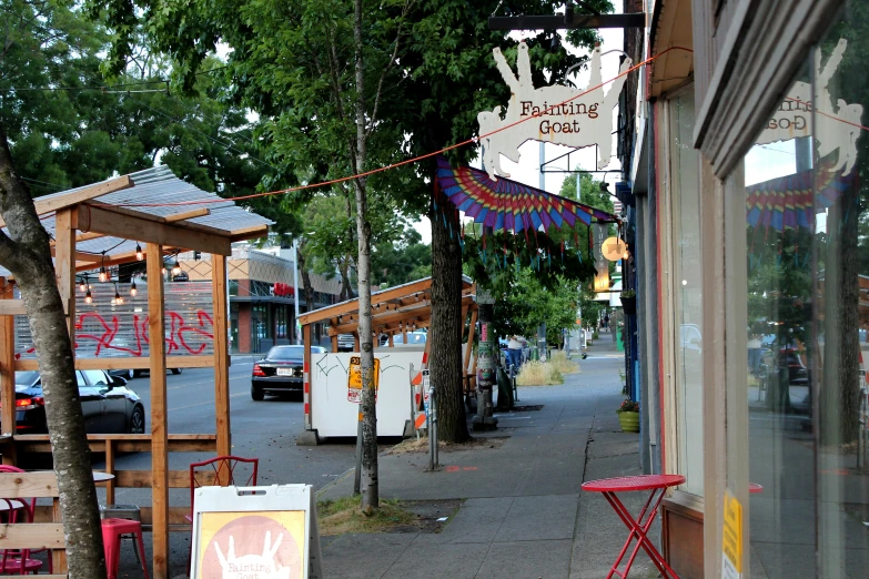 a sign hangs out next to a sidewalk