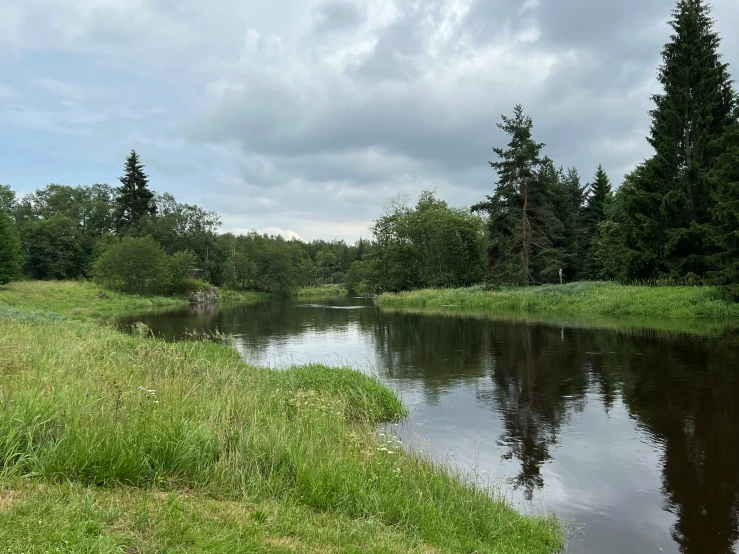 the water is calm and full of clouds