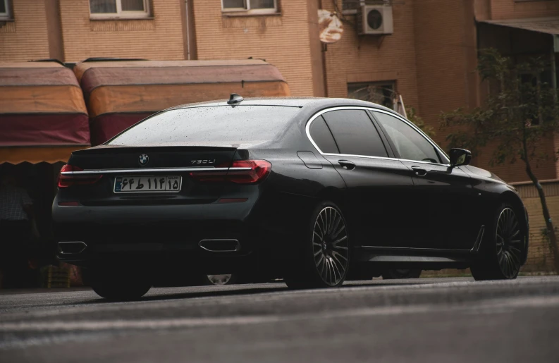 a black sedan parked on the side of a road
