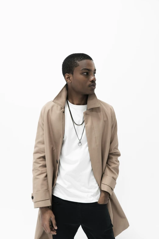 a young man standing in front of a white background