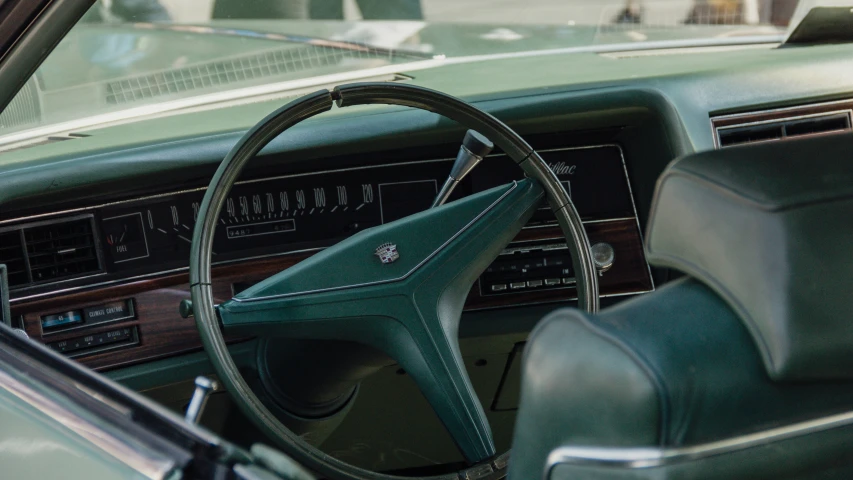 the interior of a car with a wooden steering wheel