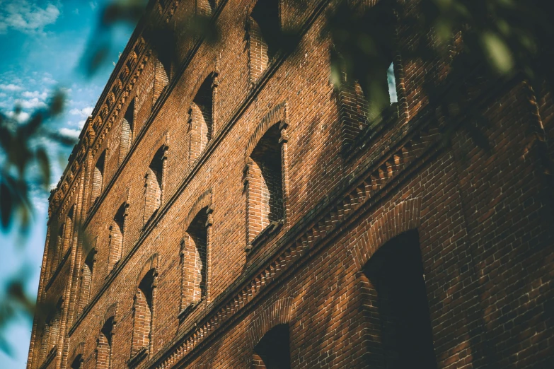 a brick tower is sitting high in the sky