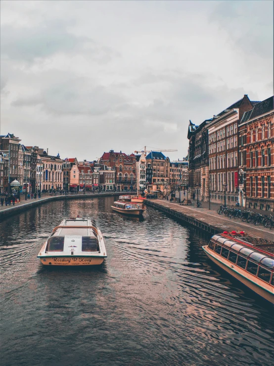 boat moving down a narrow waterway in the middle of town