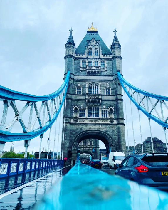 cars traveling over a bridge with the bridge in the background