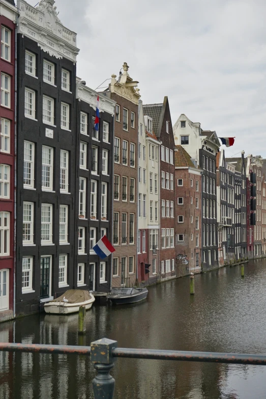 several buildings line the street and in between the river